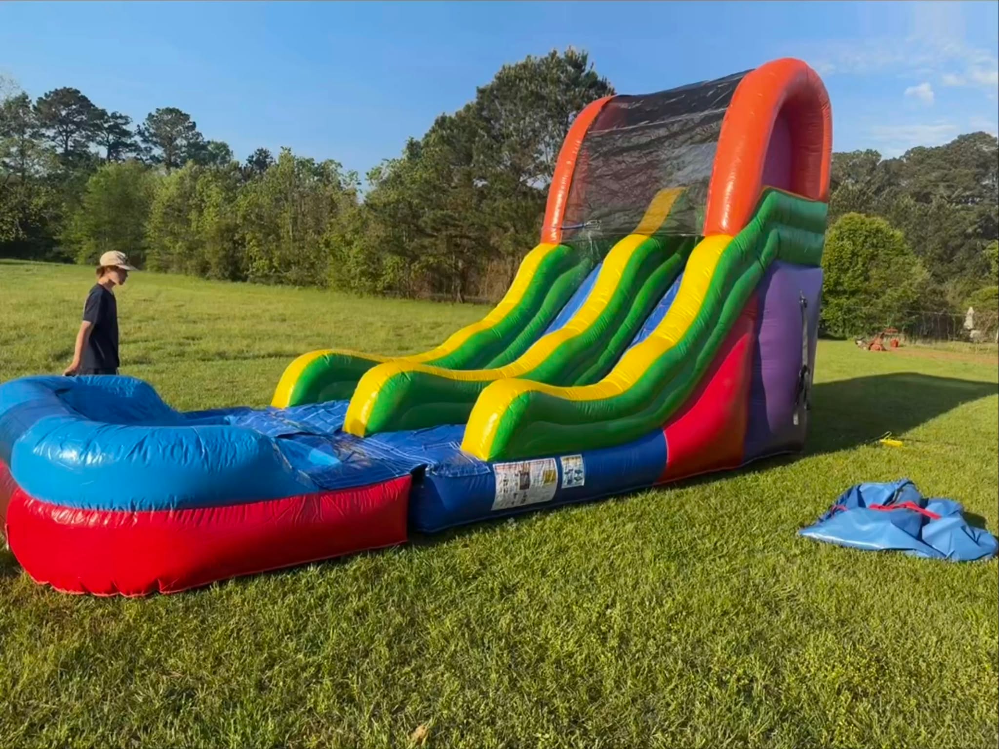 Rainbow inflatable water slide set up outside